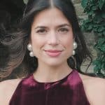 Elegant woman with pearl earrings and velvet dress for fashion and beauty photography.